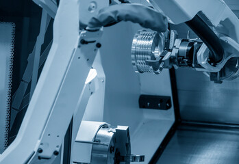 The hi-technology CNC lathe machine operation with gripping robotic system. The cobot  operation...
