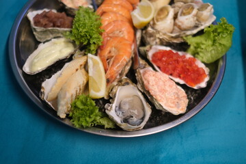 a plate of assorted seafood on a blue background in top view