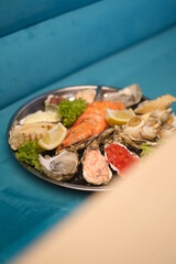 a plate of assorted seafood on a blue background in top view