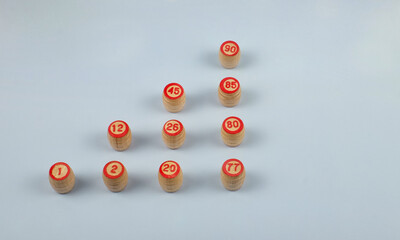 Lotto kegs as pyramid on blue background with copy space. Growth concept. Top view