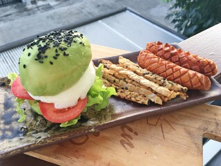 Avocado burger with soy mixed black sesame Tempeh and sausage