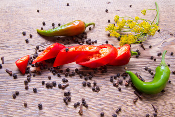A pungent and spicy peppers red green sliced with dill.Still-life