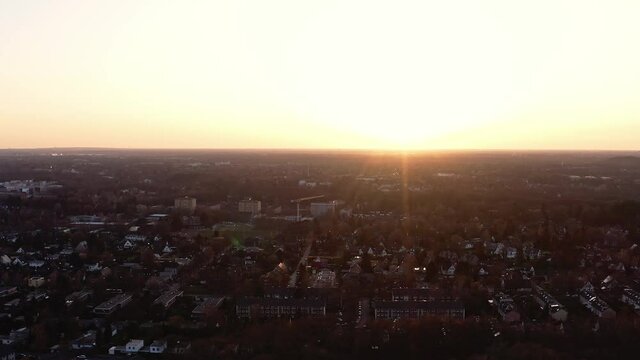 Hamburg City drone view, dazzling sun, twilight atmosphere, suset at horizone
