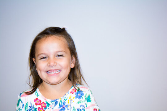 Portrait of a five year old girl making funny faces