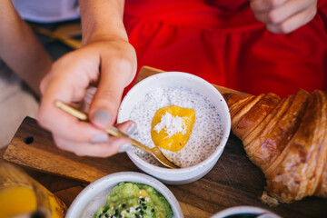 Anonymous woman enjoying tapioca pearls porridge with mango
