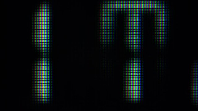 Close up on computer screen binary code on black background.