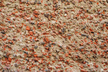 Wall with small stones frozen in concrete.