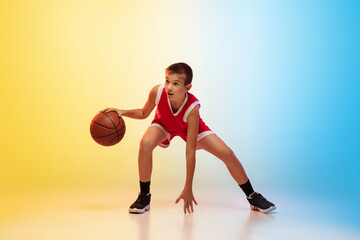Strategy. Full length portrait of young basketball player in uniform on gradient studio background....