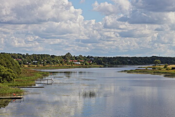 Fototapeta na wymiar Hotcha river in Tver region near Volga, beautiful natural Russian landscape at Sunny summer day on blue sky with white clouds