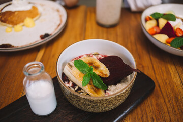 Delicious breakfast with banana in bowl
