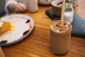 Glass of cold coffee with straw