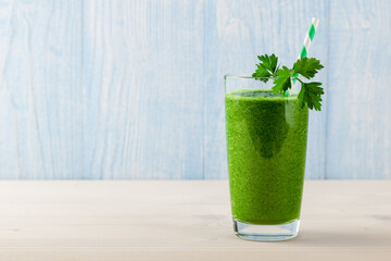Fresh green smoothie on wooden table