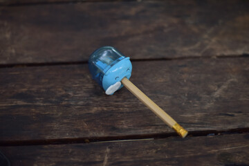 Fototapeta na wymiar Pencil with blue pig on wood table.