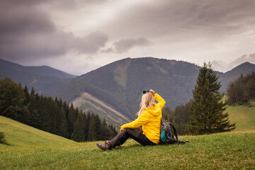 Naklejka na ściany i meble Relaxation at mountain peak. Woman tourist enjoying view after succesfully hike