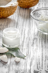 organic cosmetics with coconut on wooden background close up