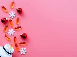Jar with pills and Christmas decorations on a pink background, flat lay, copyspace. Christmas and new year concept of medicine and health care. Greeting card for a medical professional