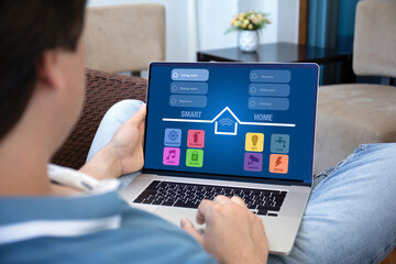 man uses application smart home laptop screen at home