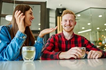 Happy couple in love enjoying weekend bonding in cafe communicating during beverage refreshing, prosperous hipster guys have sincerely conversations for discussing together recreation while dating
