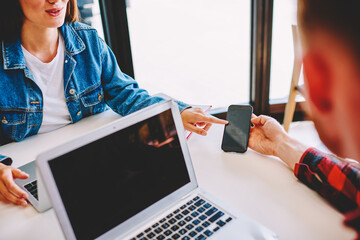 Male and female freelancers discussing received content text during co remote brainstorming in...