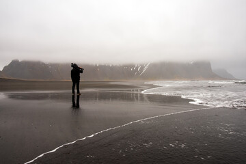 A photographer standing in front of nature ,Iceland.