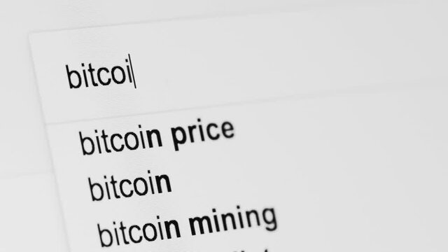 Generic internet search bar looking for the term 'BITCOIN' shot close up at an angle.