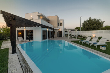 Fototapeta premium Modern house with garden swimming pool and wooden pergula