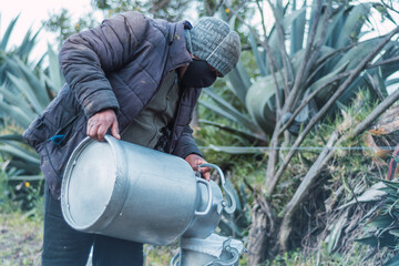 man puring milk on a millk jar