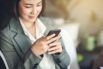 Smartphone on hand of business woman.