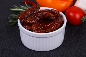 Dried tomatoes in the bowl with olive oil