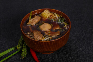 Thai style soup with meat and mushrooms