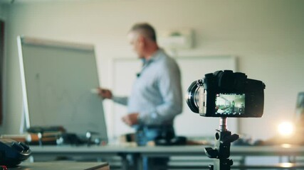A man is filming his lesson for online broadcasting