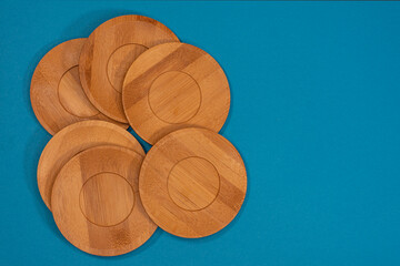 Bamboo saucers arranged in various order, with space to insert letters of text