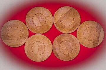 Bamboo saucers arranged in various order, with space to insert letters of text