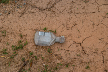 Discarded liquor bottle on the ground