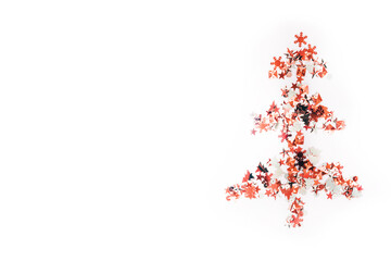 Shiny Christmas tree isolate. Figure of a Christmas tree on a white background of shiny multi-colored confetti. Happy new year and merry Christmas.