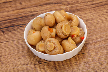 Pickled champignons in the bowl