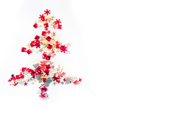 Shiny Christmas tree isolate. Figure of a Christmas tree on a white background of shiny multi-colored confetti. Happy new year and merry Christmas.