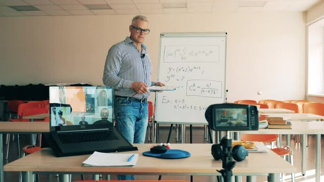Male teacher is explaining formulas for online students. Online learning, online training, online education, remote working, distance learning, distance education, remote education concept.