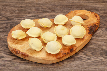 Raw dumplings over board for cooking