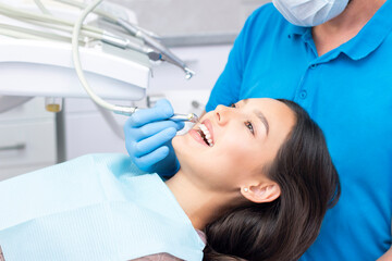 Fototapeta premium Dentist and patient in the dental office. Woman having teeth examined by dentists