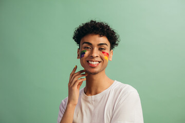 Fototapeta na wymiar Man with face paint celebrates gay pride