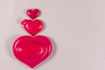 Pink hearts lined up on background with space for writing