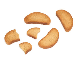 Three crispy rusks and rusk s pieces on a white background