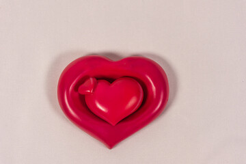 Close up of a triple heart on a neutral background