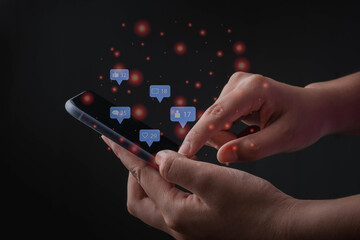 Social media interactions on smartphone ,finger touch on screen, person hands holding mobile phone, concept of notification icons of like, message, email, comment and love.