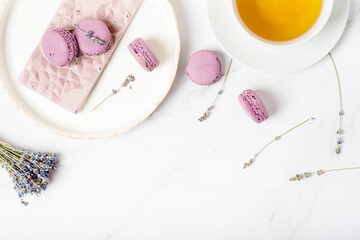 pink chocolate with lavender and macaroons on a white table