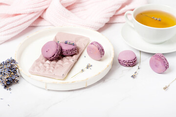 pink chocolate with lavender and macaroons on a white table