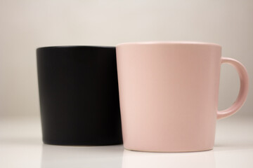 black and pink mug on a white table