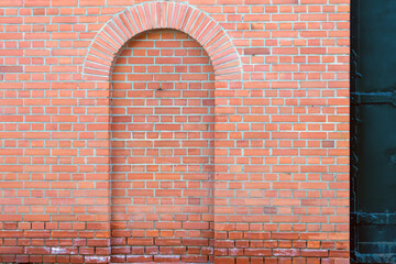 Decorative pseudo door in a red brick wall