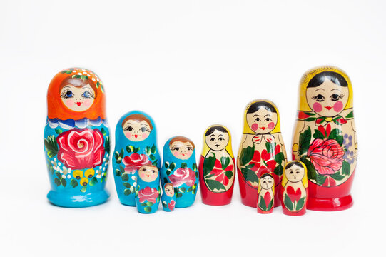 Russian doll.A set of wooden dolls of different colors on a white background